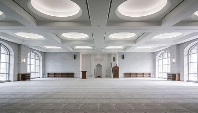 Minimalist white mosque prayer hall featuring domed ceilings, mihrab and minbar