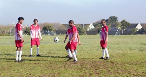 Diverse Male Soccer Players Practicing on Field