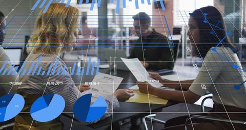 Business Team Analyzing Reports with Data Visualizations Overlay