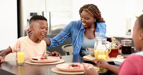 Happy Family Enjoying Lunch Together at Dining Table