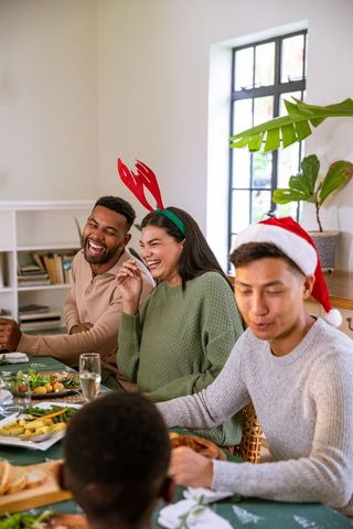 Joyful Friends Celebrating Around Holiday Dining Table