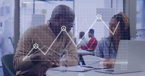 Senior Professional Engaged in Collaborative Meeting with Young Woman in Office