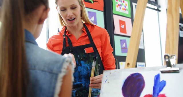 Art Teacher Guiding Student During Painting Class - Download Free Stock Images Pikwizard.com