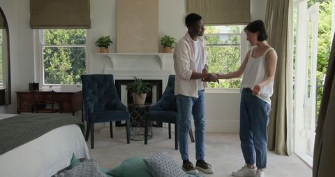 Couple Joyfully Dancing in Cozy Home Interior Setting
