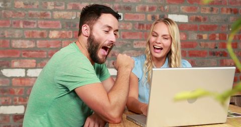 Team Sharing Exciting Accomplishments in Modern Workspace