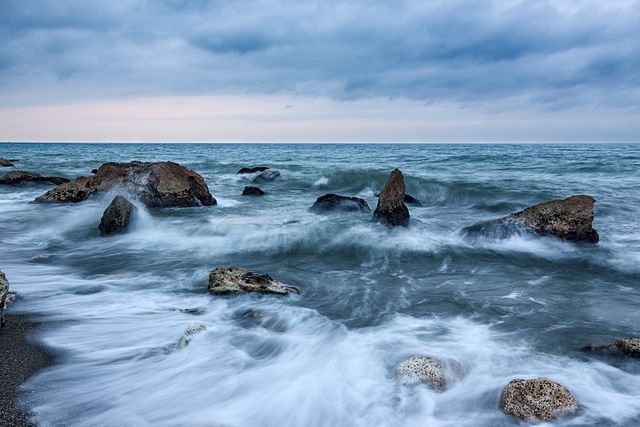 Rough Sea Waves Crashing Against Rocky Shoreline at Twilight - Download Free Stock Photos Pikwizard.com