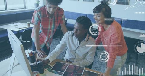 Creative team reviewing prints and monitor in design studio with dslr and digital overlays