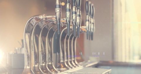 Beer taps with sunlight drenched scene in bar