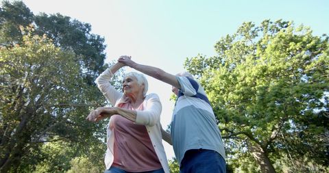 Elderly Couple Dancing Outdoors in Sunlit Garden - Download Free Stock Images Pikwizard.com