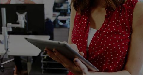 Woman Using Tablet in Open-Plan Office