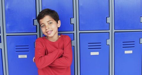 Confident Schoolboy Leaning Against Blue Lockers - Download Free Stock Images Pikwizard.com