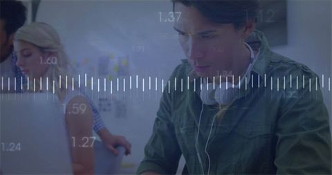 Young Professional Working with Headphones in Modern Office