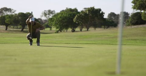 Caucasian Male Golf Player Focusing on Putting at Golf Course - Download Free Stock Images Pikwizard.com