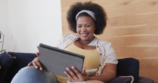 Woman Relaxing at Home Smiling While Using Digital Tablet - Download Free Stock Images Pikwizard.com