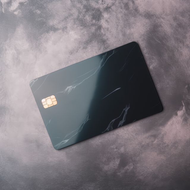 Blank black credit card with microchip on grey, copy space, created using generative ai technology. Emv chip, banking, spending, technology and finance mock up concept digitally generated image.