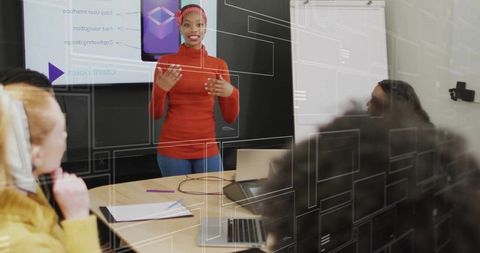 Confident Businesswoman Presenting Mobile App Mockup in Meeting