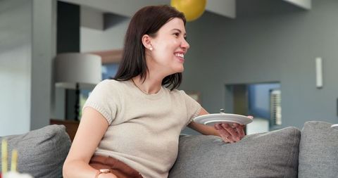 Young Woman Enjoying Cake at Social Gathering