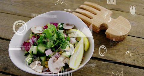 Topdown bowl holding fresh mushroom cucumber salad with lemon wedges and wooden servers, ar overlay