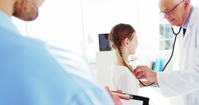 Doctor Examining Young Girl with Stethoscope in Clinic - Download Free Stock Images Pikwizard.com