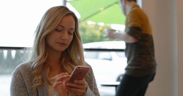 Young Woman Using Smartphone in Cozy Cafe - Download Free Stock Images Pikwizard.com