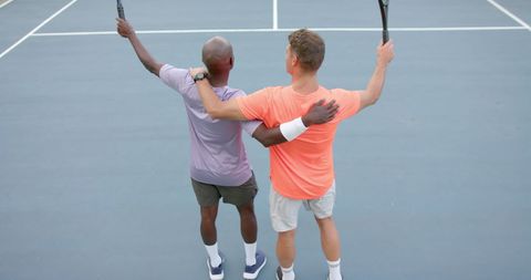 Celebrating Friendship On Tennis Court Outdoors