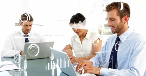Business team collaborating and analyzing data with laptops and hud charts in modern boardroom