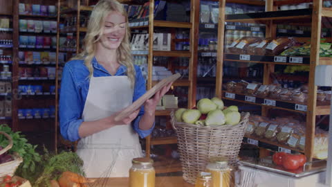 Smiling Shopkeeper Handling Grocery Provisions