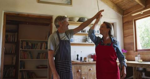 Senior Couple Dancing in Comfortable Kitchen Setting