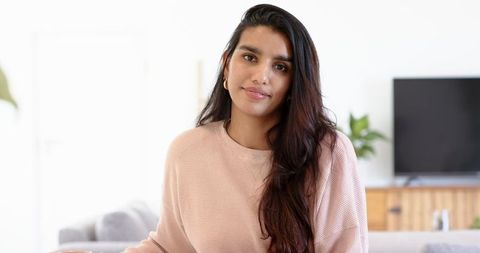 Relaxing in Contemporary Living Room with Indian Woman at Home