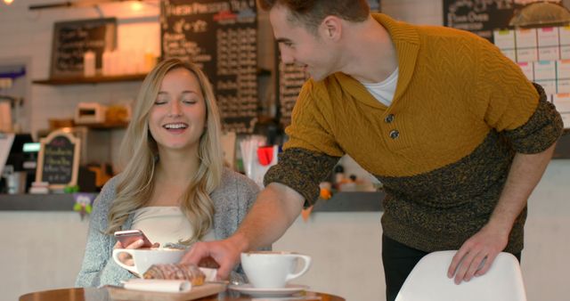 Young Couple Smiling While Sharing Coffee and Pastry in Cozy Cafe - Download Free Stock Images Pikwizard.com