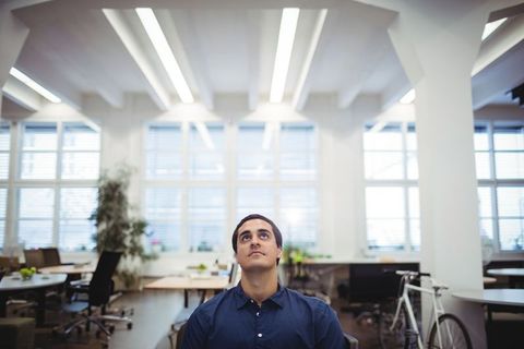 Professional Man Seeking Inspiration in Modern Office