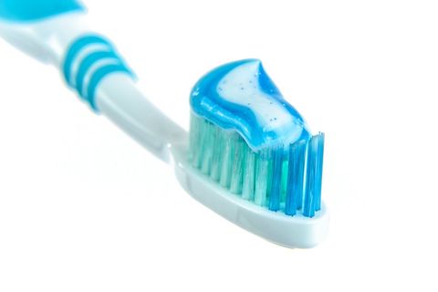 Colorful toothbrush loaded with minty toothpaste in celebration of national dental hygiene month