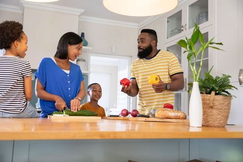 Diverse family cooking together in modern kitchen setting