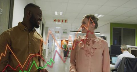 Colleagues walking and discussing analytics with colorful overlaid growth charts