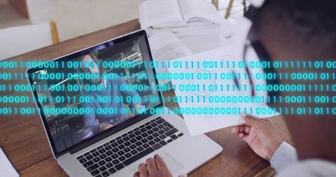Remote collaboration and data analysis on laptop with binary code overlay