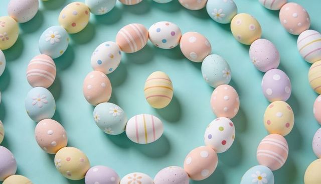 Arranging pastel easter eggs into spiral on mint background for spring decor
