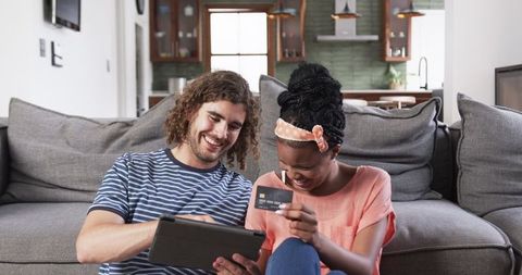 Couple Shopping Online Together While Relaxing at Home