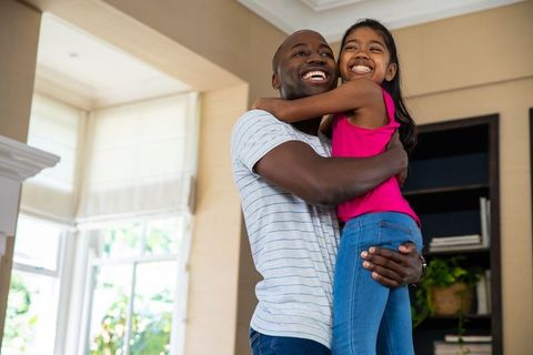 Loving Father Hugging Daughter in Cozy Home Environment