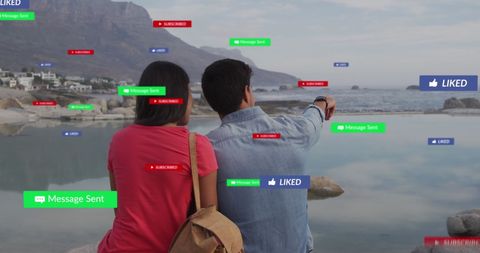 Couple Seated on Beach with Floating Social Media Icons