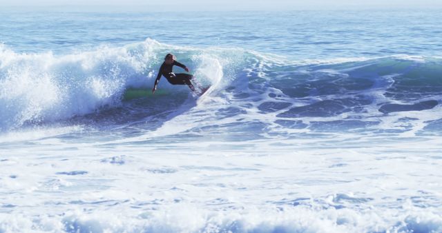 A young Caucasian male surfer is riding a wave in the ocean, with copy space - Download Free Stock Photos Pikwizard.com