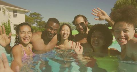 Diverse Group of Friends Having Fun in a Swimming Pool