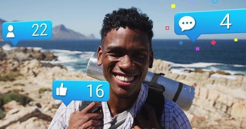 Smiling hiker enjoying ocean view with social media engagement