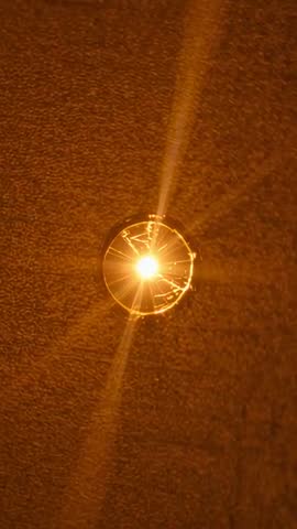 Handheld Camera Shaking Causing Ceiling Light Starburst Amber Glow Moving Down Corridor