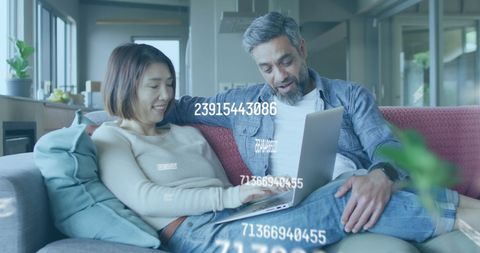 Couple analyzing data together with changing numbers overlay