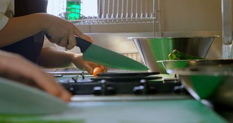 Chef Demonstrating Precise Knife Skills in Modern Kitchen - Download Free Stock Images Pikwizard.com