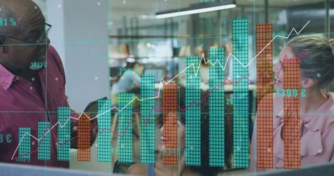 Collaborating team reviewing interactive data visualization overlay on office glass wall