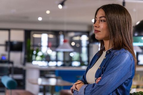 Confident female developer in office working on api, json, automation and data