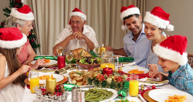 Family Celebrating Christmas Dinner Together with Santa Hats - Download Free Stock Images Pikwizard.com