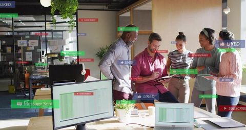 Creative team collaborating around tablet in modern office with social media overlays