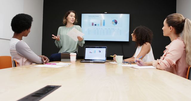 Businesswoman Leading Team Meeting and Presenting Data on Digital Screen - Download Free Stock Images Pikwizard.com